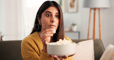 Buy stock photo Woman, eating and watching tv on couch with popcorn for entertainment, film and relax on weekend. Shocked person, streaming service or subscription with snack in apartment for movie, show and series.