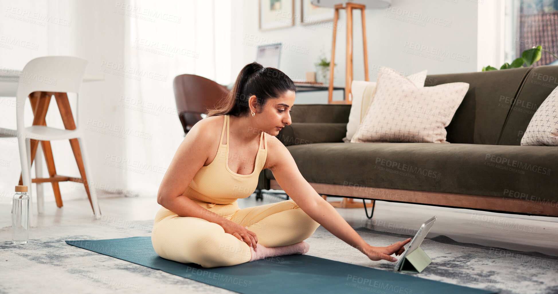 Buy stock photo Yoga, home and woman typing with tablet, search warm up routine or online pilates tutorial. Digital class, fitness live stream and person browsing with technology for exercise video, lounge and mat