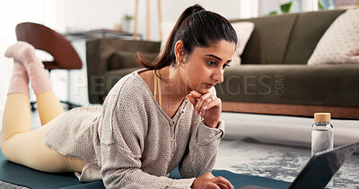 Buy stock photo Fitness, home or woman thinking with laptop, search warm up routine or online pilates tutorial. Lounge, yoga mat or person browsing with computer for exercise video, digital class or live stream