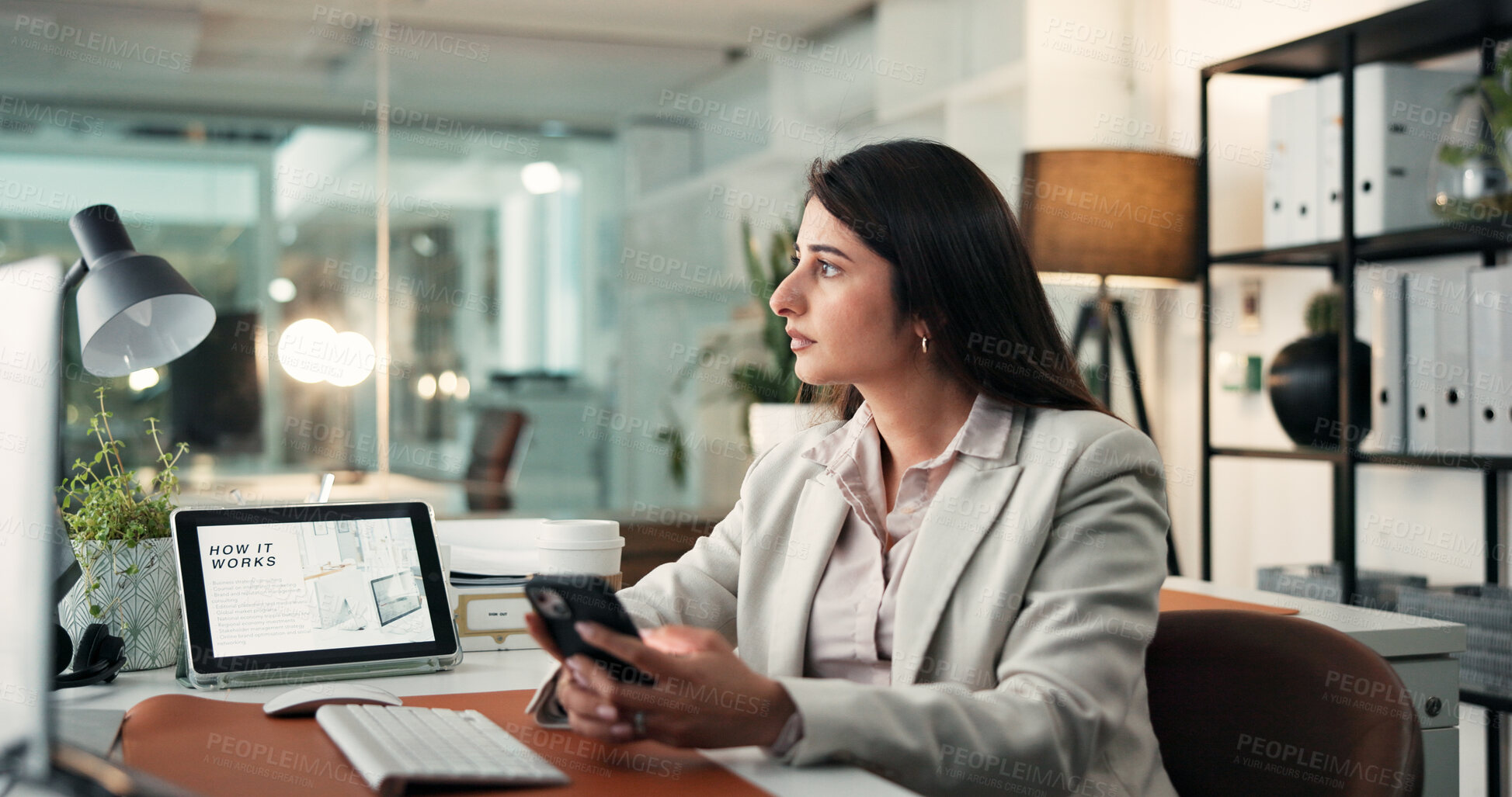 Buy stock photo Woman, smartphone and thinking at startup with networking, decision and computer for project at office. Person, phone or advisor with mobile app, pc screen or insight at business consulting agency