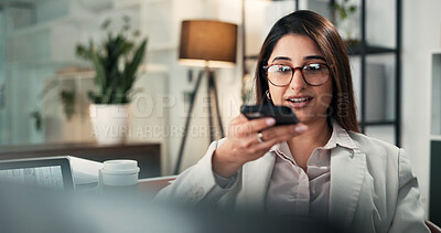 Buy stock photo Laptop, phone and voicenote with business woman in office at night for contact, recording or reminder. App, computer and mobile with Indian employee at work in evening for communication or update