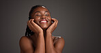Black woman, skincare and happy for touch in studio, natural glow or mockup space on dark background. African girl, beauty and smile with thinking, cosmetics or soft texture with dermatology benefits