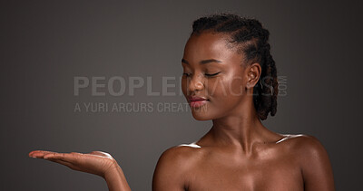 Buy stock photo Mockup space, skincare and black woman in studio for product placement, beauty and wellness. Advertising, salon and person with hands for dermatology review, healthy skin and glow on dark background