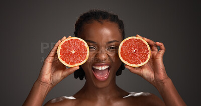Buy stock photo Skincare, grapefruit and portrait of black woman in studio with natural, health or organic glow. Vitamin c, smile and African person with citrus fruit for dermatology hydration by gray background.