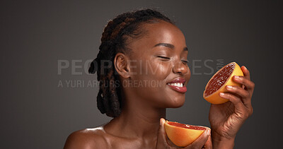 Buy stock photo Grapefruit, happy and black woman in studio for skincare, cosmetics and vitamin c on dark background. Space, dermatology and person with fruit for organic products, natural beauty and hydration