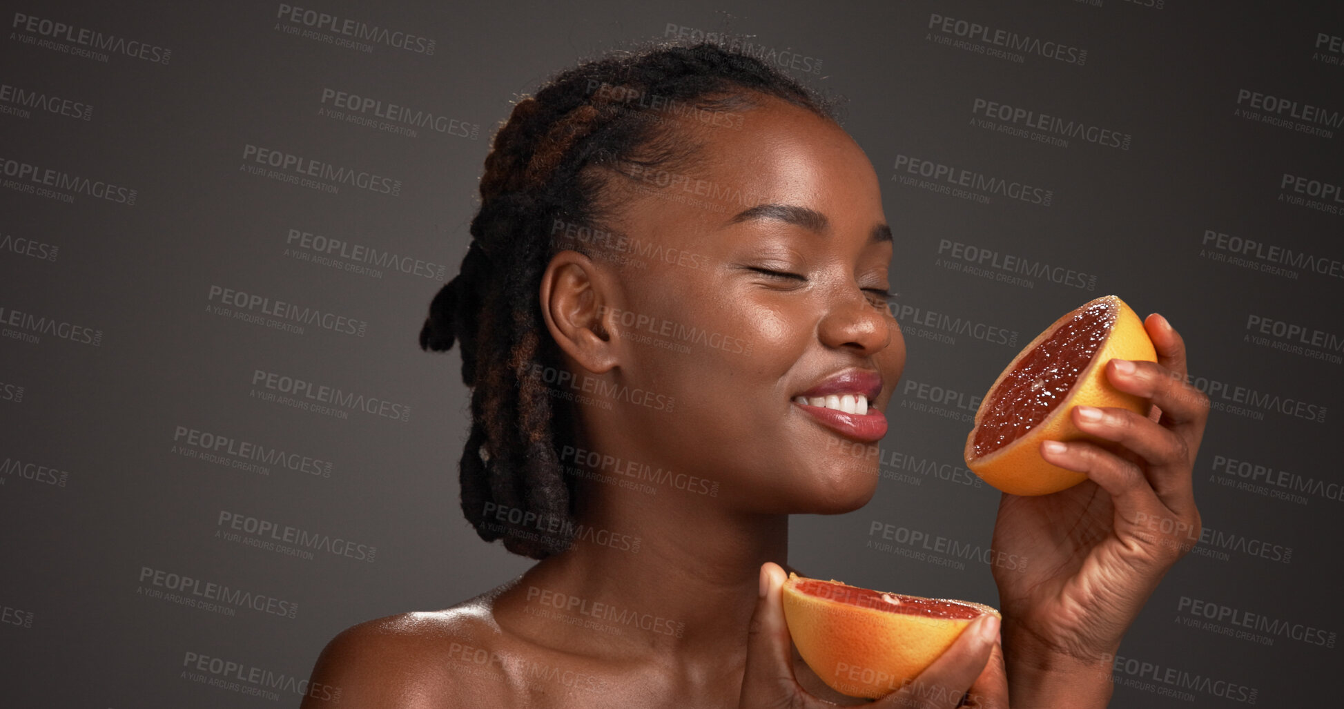 Buy stock photo Grapefruit, happy and black woman in studio for skincare, cosmetics and vitamin c on dark background. Space, dermatology and person with fruit for organic products, natural beauty and hydration