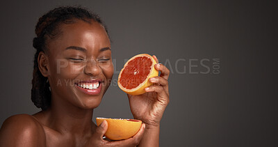 Buy stock photo Skincare, grapefruit and black woman in studio with beauty, health or organic facial glow. Vitamin c, space and African female person with citrus fruit for dermatology hydration by gray background.