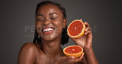 Buy stock photo Skincare, grapefruit and black woman in studio with health, natural or organic facial glow. Vitamin c, space and African female person with citrus fruit for dermatology hydration by gray background.