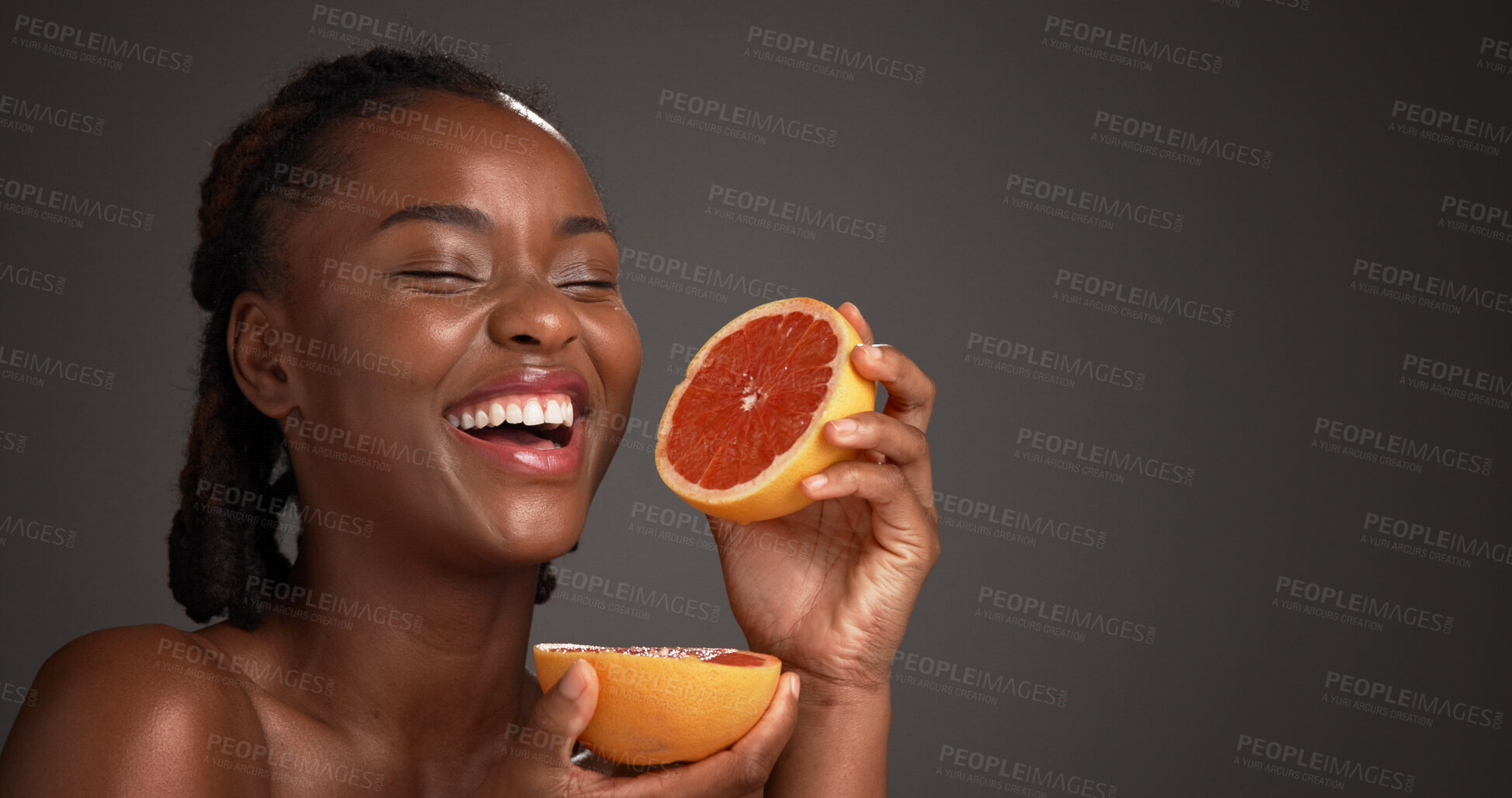 Buy stock photo Laugh, grapefruit and black woman in studio with natural, skincare or organic facial glow. Vitamin c, space and African female person with citrus fruit for dermatology hydration by gray background.