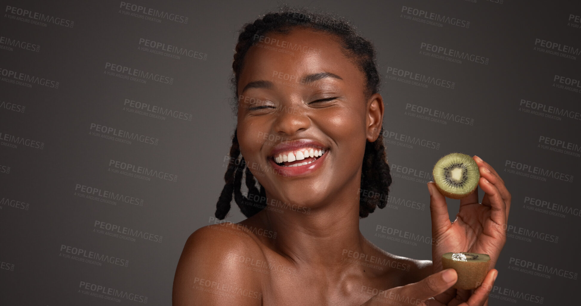 Buy stock photo Skincare, kiwi and happy black woman in studio for organic cosmetics, wellness and self care. Dark background, space and person with fruit for natural beauty, vitamin c and dermatology benefits