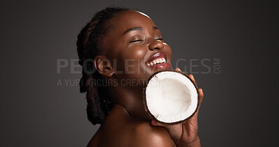 Buy stock photo Skincare, coconut and black woman in studio with health, natural and organic facial glow. Happy, space and African female person with fruit for face hydration with dermatology by gray background.