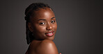 Portrait, confident and woman with smile, skincare and natural cosmetics for healthy skin and beauty. Gray background, happy black person and shine with dermatology, mockup space or studio in Nigeria