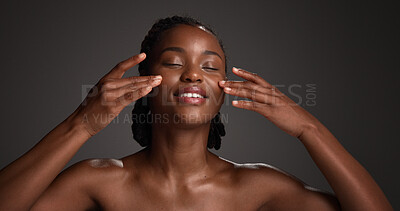 Buy stock photo Skincare, natural beauty and black woman with hands in studio for hydration, wellness and cosmetics. Space, dermatology and person with touch, smile and aesthetic for healthy skin on dark background