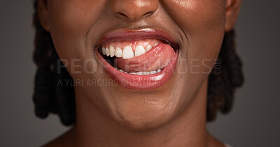 Buy stock photo Dental, closeup or black woman in studio with lick, mouth or tooth wellness in orthodontics. Lips, happiness and female person on gray background with hygiene, whitening or dentistry in oral health.
