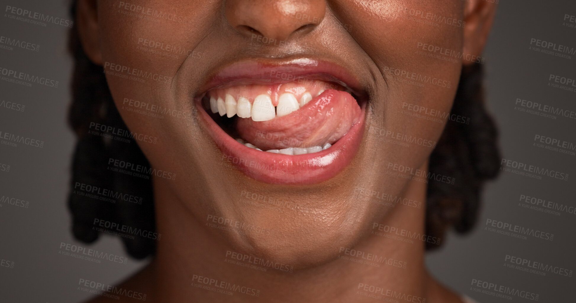 Buy stock photo Dental, closeup or black woman in studio with lick, mouth or tooth wellness in orthodontics. Lips, happiness and female person on gray background with hygiene, whitening or dentistry in oral health.