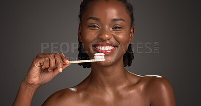 Buy stock photo Black woman, portrait or dental care with toothbrush in studio for hygiene on a gray background. Female person, model or smile with paste or bamboo stick for cleaning teeth or eco friendly gum health