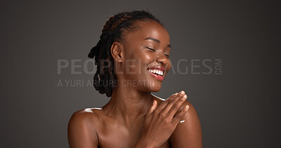 Buy stock photo Beauty, skincare and black woman with cream in studio, hydration or wellness benefits in apply. Shine, dermatology or person with moisturizing lotion for glow, body care and space on gray background