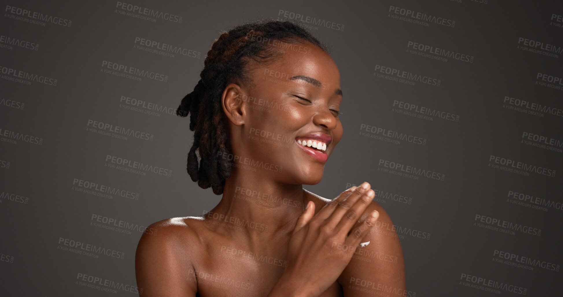 Buy stock photo Beauty, skincare and black woman with cream in studio, hydration or wellness benefits in apply. Shine, dermatology or person with moisturizing lotion for glow, body care and space on gray background