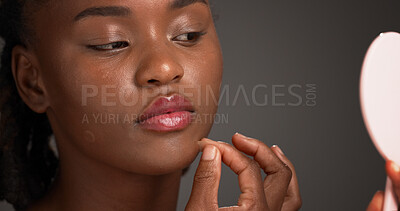 Buy stock photo Acne patch, beauty and mirror with black woman on studio space for cosmetics or dermatology. Inspection, routine and skincare with African model isolated on gray background to remove pimple or zit