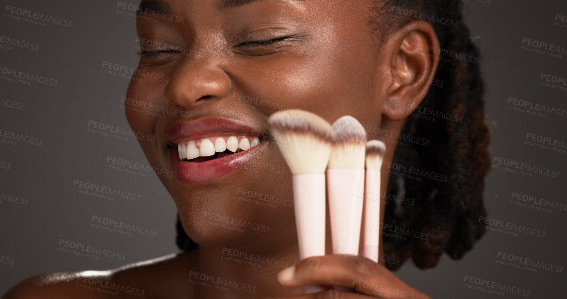 Buy stock photo Brush, makeup and happy black woman in studio for cosmetics, makeover and application. Cosmetology, smile and person with tools for foundation, beauty products and salon aesthetic on dark background