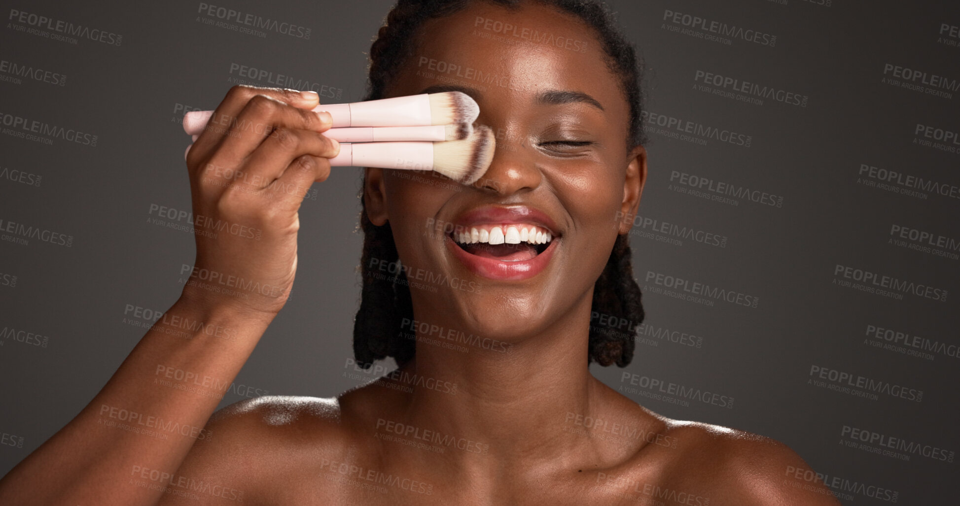 Buy stock photo Brushes, makeup and happy black woman in studio for cosmetics, makeover and application. Cosmetology, space and person with tools for foundation, beauty products and aesthetic on dark background
