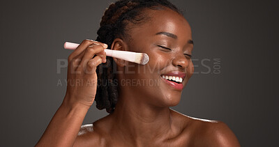 Buy stock photo Black woman, makeup brush and happy in studio with beauty, foundation and space on dark background. African girl, smile and cosmetics tools for powder, excited or concealer for facial transformation