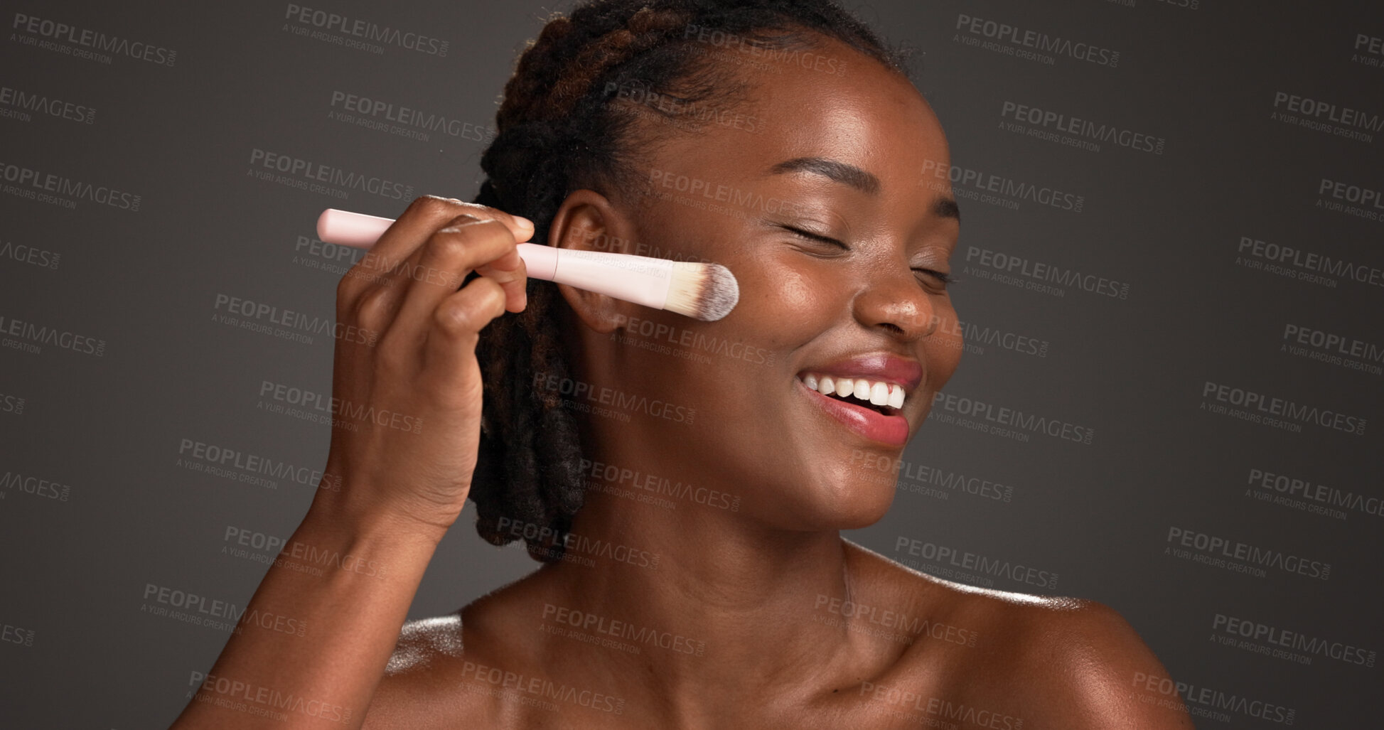 Buy stock photo Black woman, makeup brush and happy in studio with beauty, foundation and space on dark background. African girl, smile and cosmetics tools for powder, excited or concealer for facial transformation