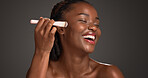 Black woman, makeup brush and laugh with beauty in studio, space and foundation on dark background. African girl, happy and cosmetic tools for powder, concealer and excited with product for skin