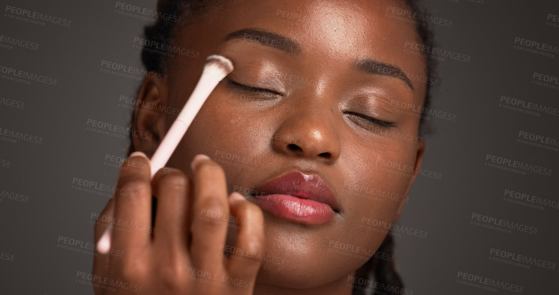 Buy stock photo Woman, makeup brush or eyeshadow in studio for application, beauty aesthetic or glowing skin. Black person, apply cosmetic or powder with tool for transformation, wellness or shine on gray background