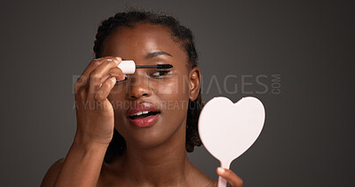 Buy stock photo Studio, mirror and woman with mascara, self care and cosmetics application for eyelashes and makeup. Gray background, makeover and black person with tools for beauty extension, glow or transformation