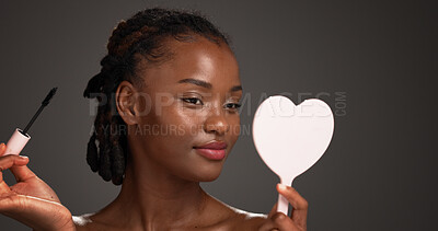 Buy stock photo Studio, mirror and woman with mascara, beauty and cosmetics application for eyelashes and self care. Gray background, makeup and black person with tools for extension results, glow or transformation