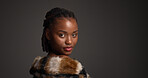 Beauty, fur coat and portrait with black woman on studio space for cosmetics or dermatology. Aesthetic, confident and fashion with serious African model isolated on gray background for skincare