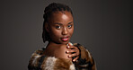 Beauty, portrait and shoulder with black woman on studio space for cosmetics or dermatology. Aesthetic, confident and fur coat with serious African model isolated on gray background for skincare