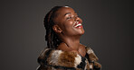 Smile, black woman and makeup for beauty in studio with cosmetics, facial glow and aesthetic. Space, female person and confidence of luxury shine, fur coat and glamour for makeover on gray background