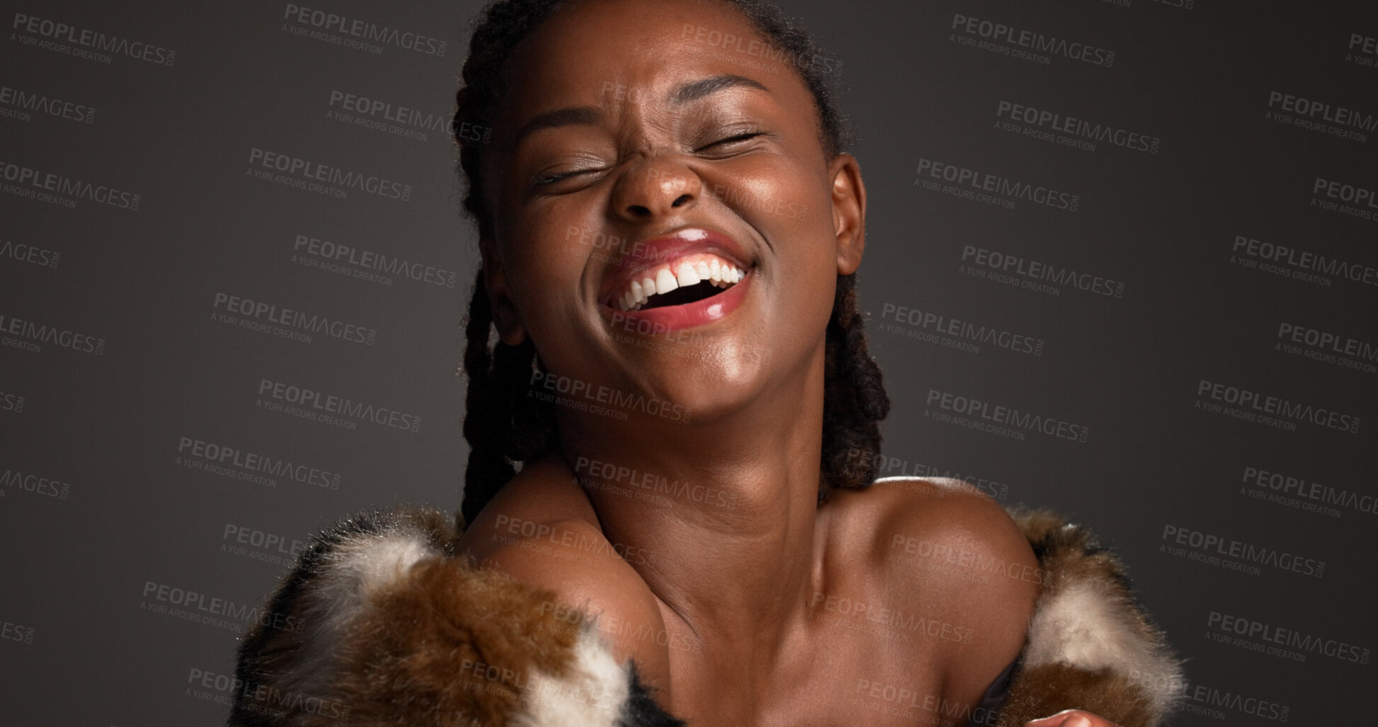 Buy stock photo Happy, black woman and makeup for beauty in studio with cosmetics, facial glow and aesthetic. Space, female person and laughing with luxury shine, fur coat and glamour for makeover on gray background