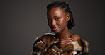 Portrait, black woman and makeup for beauty in studio with cosmetics, facial glow and aesthetic. Space, female person and proud with luxury shine, fur coat and glamour for makeover on gray background