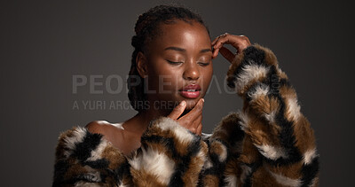 Buy stock photo Makeup, beauty and black woman in studio with self care, glow and glamour with cosmetology. Luxury, cosmetics and model with fur coat for aesthetic, makeover and touch face on dark background
