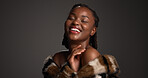Smile, black woman and laughing for beauty in studio with cosmetics, facial glow and aesthetic. Space, female person and makeup for luxury shine, fur coat and glamour for makeover on gray background
