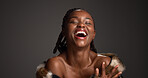 Happy, black woman and laughing for beauty in studio with cosmetics, facial glow and aesthetic. Space, female person and makeup for luxury shine, fur coat and glamour for makeover on gray background