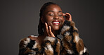 Skincare, dermatology and happy black woman with beauty, self care and glamour in studio. Makeup, fur coat and model with cosmetics for luxury aesthetic, healthy skin or touch face on dark background