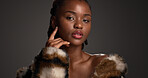 Beauty, fashion and portrait with black woman on studio space for cosmetics or dermatology. Aesthetic, fur coat and pride with confident African model isolated on gray background for skincare