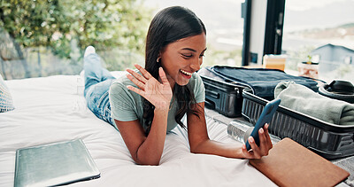 Buy stock photo Happy woman, wave or video call with phone in hotel for travel, vacation or accomodation on bed. Female person, traveler or tourist with smile, mobile smartphone or suitcase for chat, app or check in