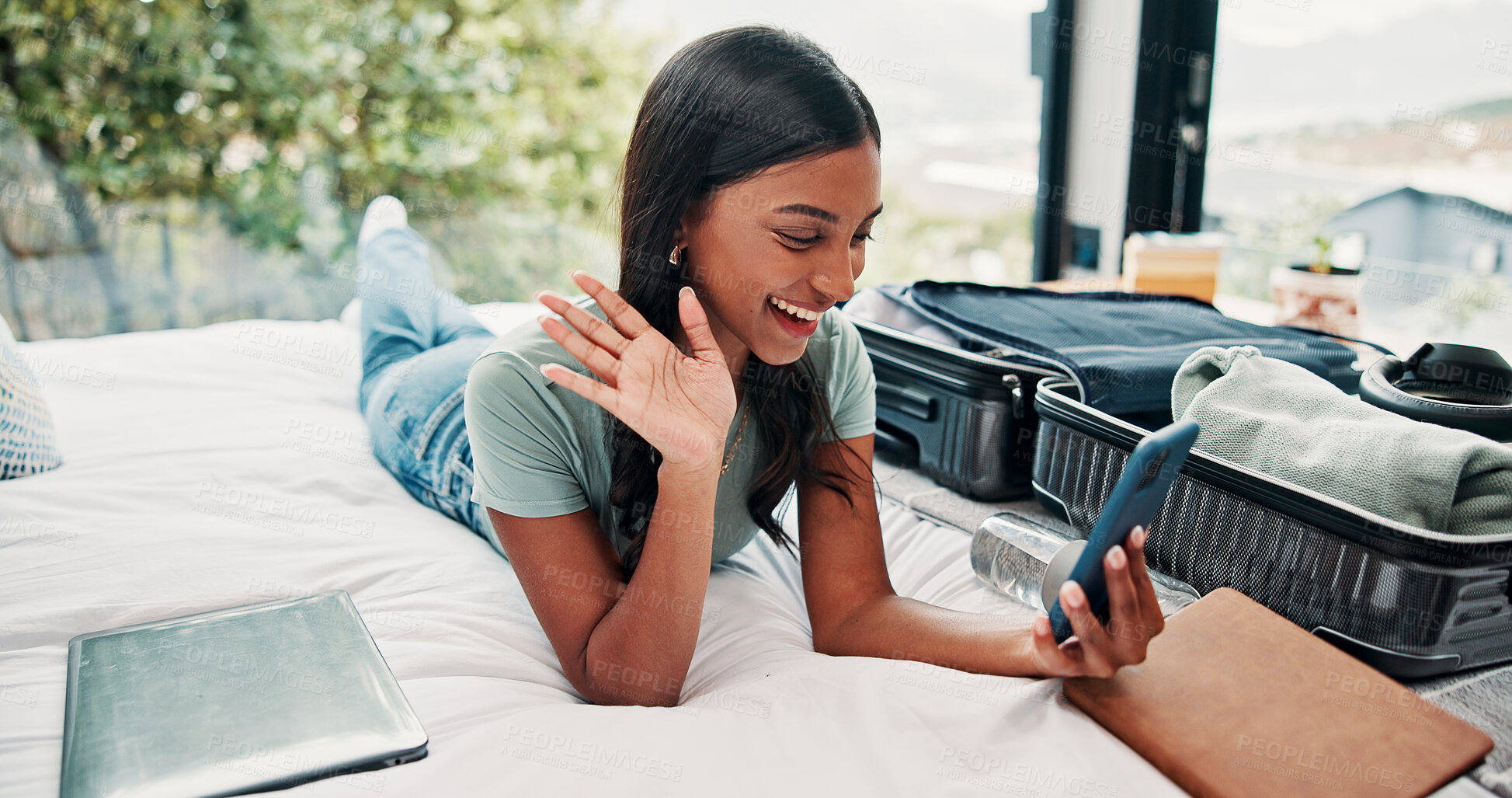 Buy stock photo Happy woman, wave or video call with phone in hotel for travel, vacation or accomodation on bed. Female person, traveler or tourist with smile, mobile smartphone or suitcase for chat, app or check in