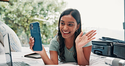 Buy stock photo Happy woman, wave or video call with phone in bed for travel, vacation or accomodation in hotel. Female person, traveler or tourist with smile, mobile smartphone or suitcase for chat, app or check in
