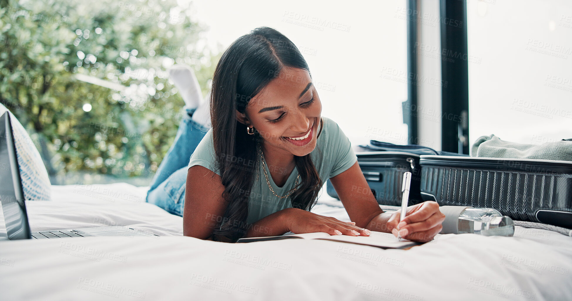 Buy stock photo Happy woman, writing and bed with suitcase for travel journal, to do list or vacation in hotel. Female person, traveler or tourist with smile, diary or luggage for accommodation experience or review