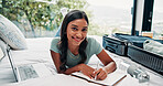 Happy woman, portrait and writing with suitcase for vacation, holiday or to do list on hotel bed. Female person, traveler or tourist with smile, diary or travel journal for luggage checklist or trip