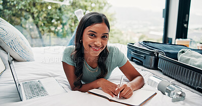 Buy stock photo Happy woman, portrait and writing with suitcase for vacation, holiday or to do list on hotel bed. Female person, traveler or tourist with smile, diary or travel journal for luggage checklist or trip