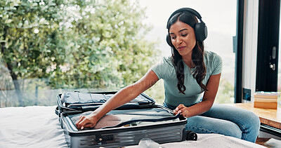 Buy stock photo Packing, home and woman with suitcase, headphones and clothes for vacation, sound and smile. Apartment, travel and happy person with audio, holiday trip and listening to music, tourism and prepare