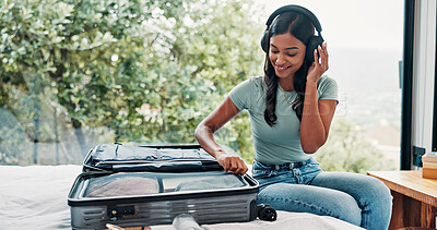 Buy stock photo Packing, home and woman with baggage, headphones and clothes for vacation, sound and smile. Luggage, accommodation or happy person with audio, holiday trip and listening to music, suitcase or prepare