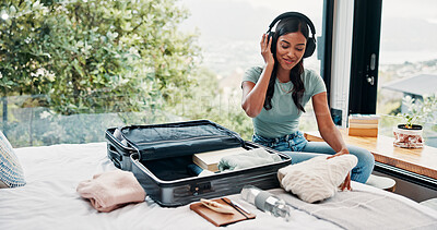 Buy stock photo Packing, home and woman with suitcase, headphones and clothes for vacation, radio and smile. Luggage, travel and happy person with sound, holiday trip and listening to music, tourism and prepare